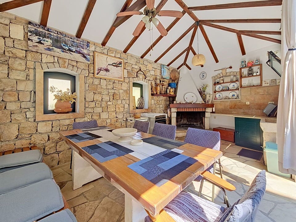 Furniture, Ceiling, Chair, Brick, Kitchen & Dining Room Table, Wood Stain, Light Fixture, Stone Wall, Beam, Living Room