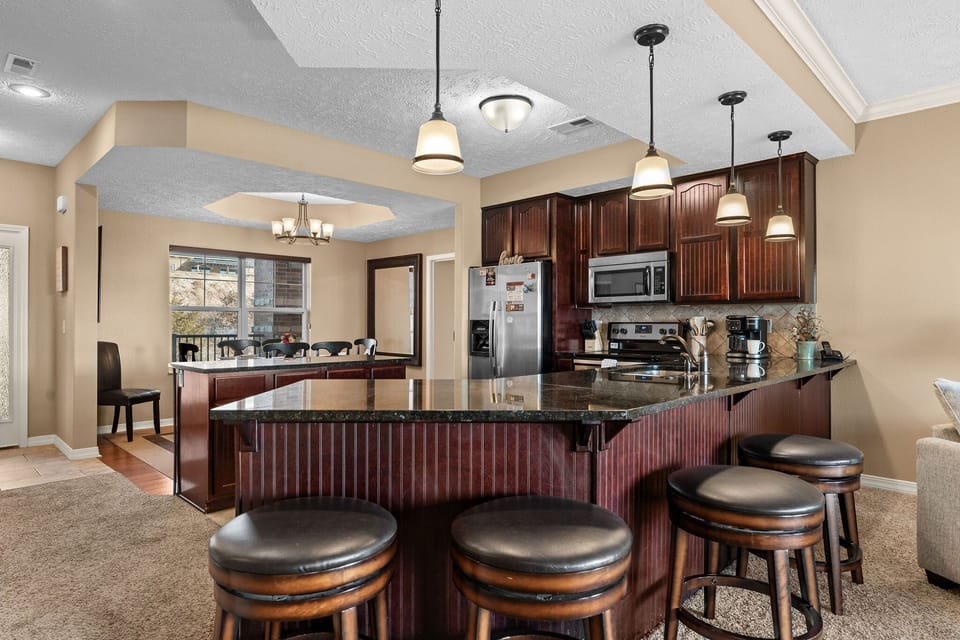 Fully Equipped Kitchen with Upgraded Appliances and Extra Seating at the Counter