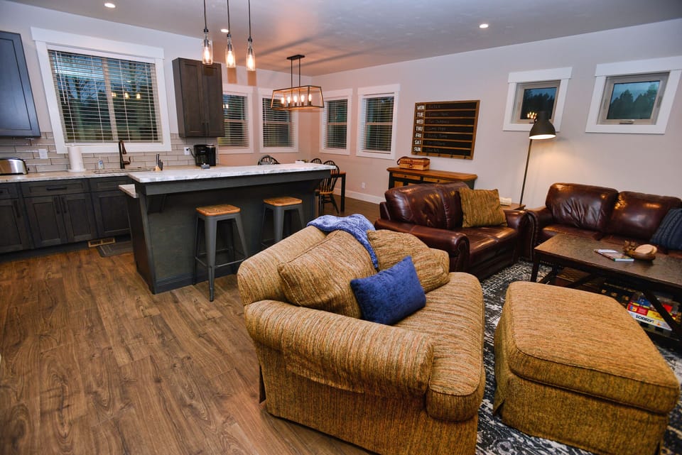 Living area, breakfast bar and kitchen flow into one open space.