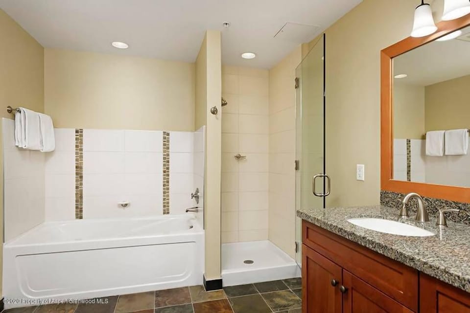 Master Bathroom with Tub, shower, and double vanity