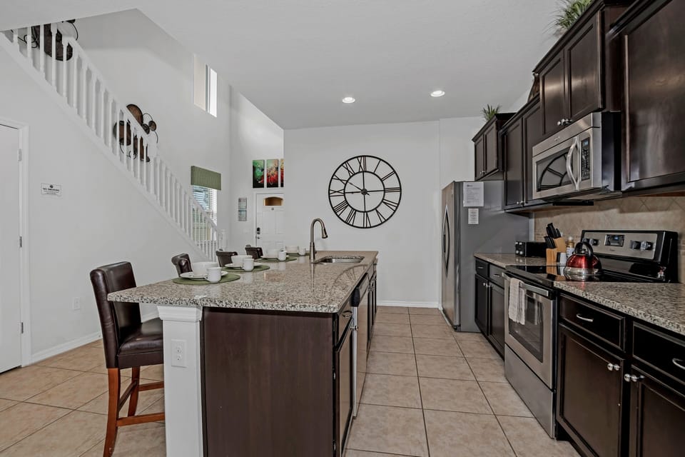 Indulge in panoramic luxury at our fully equipped kitchen and dining area in Kissimmee, Florida.