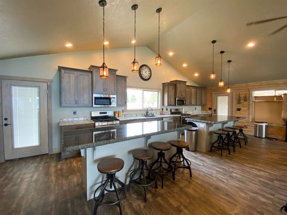 Open rustic kitchen with ample seating, perfect for gathering, cooking, and creating lasting memories.