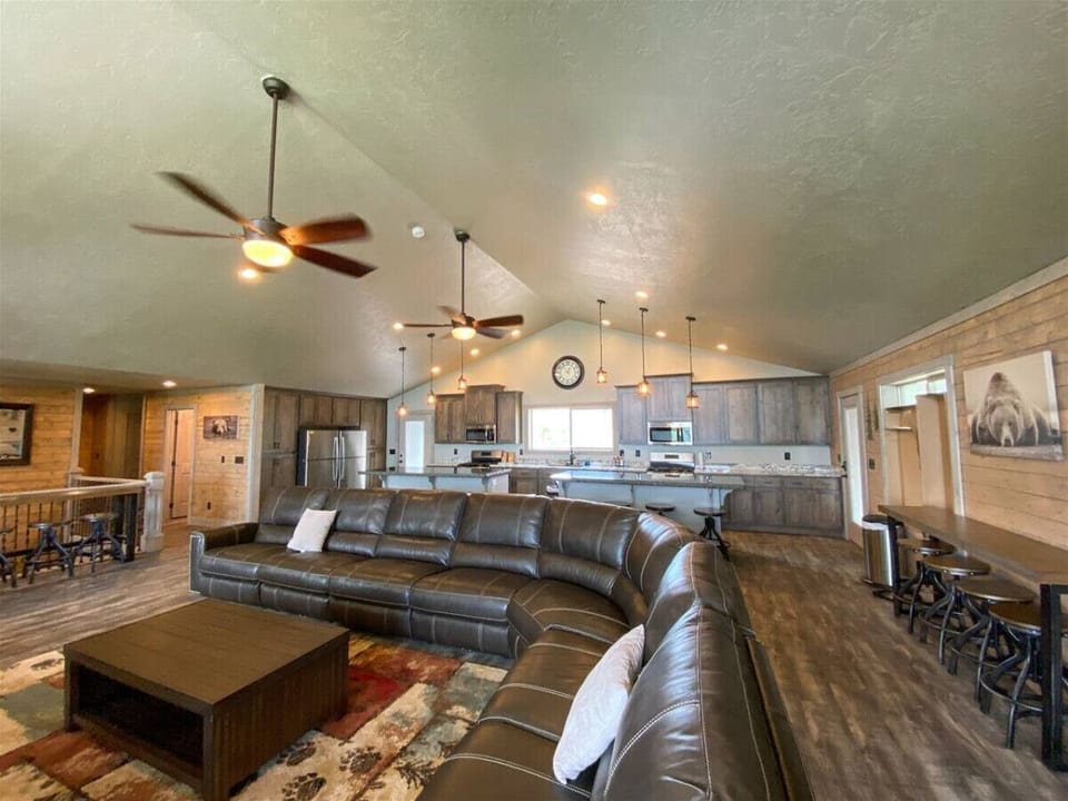 Spacious open-concept living with cozy leather seating and rustic charm—perfect for gathering and relaxing.