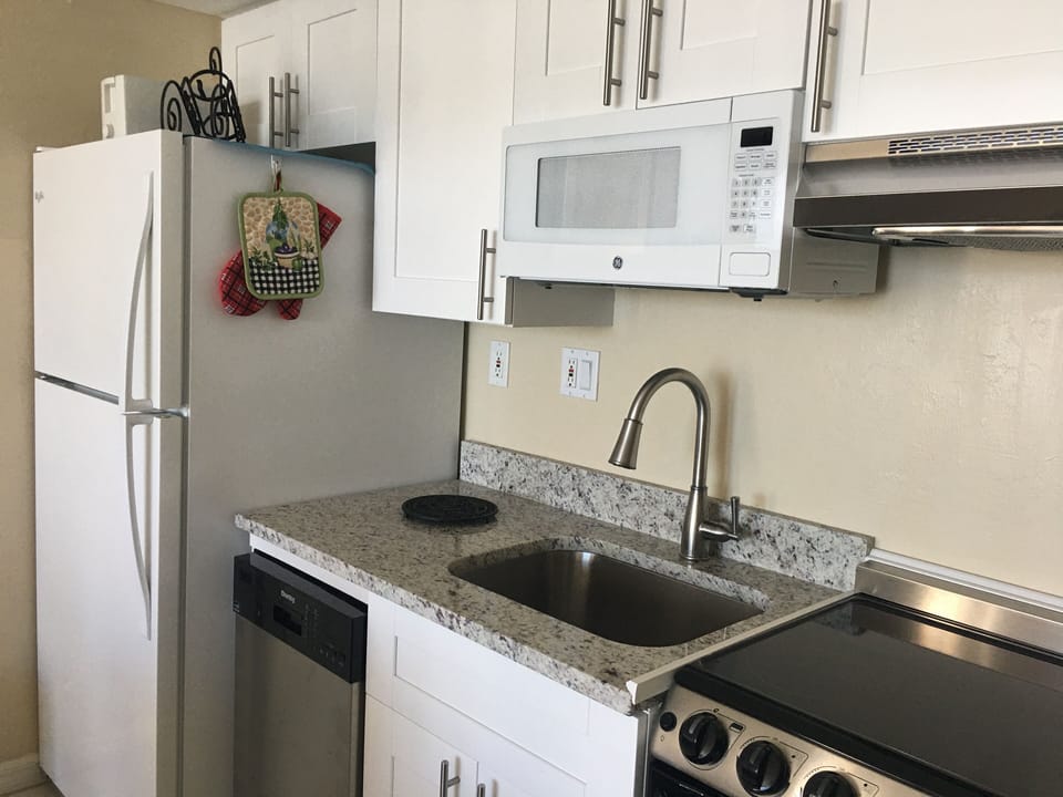 New kitchen sink, stove, microwave, cabinets, dishwasher, granite countertop