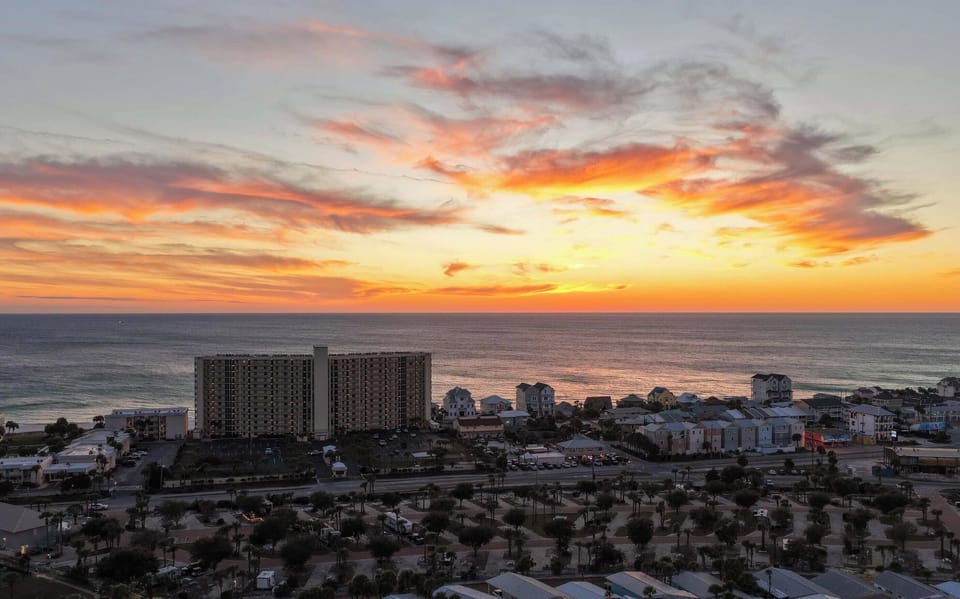 The Gulf Coast lights up in orange and pink — another perfect Panama City Beach sunset from The Commodore.
