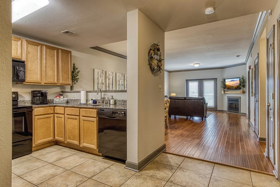 Kitchen is located near entry hallway & opens to dining & living room