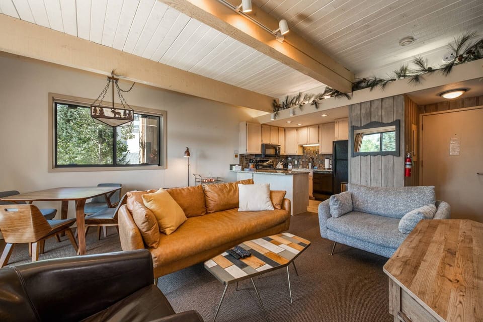 Comfortable open-concept living room close to the kitchen—perfect for relaxing and cooking after a day out.