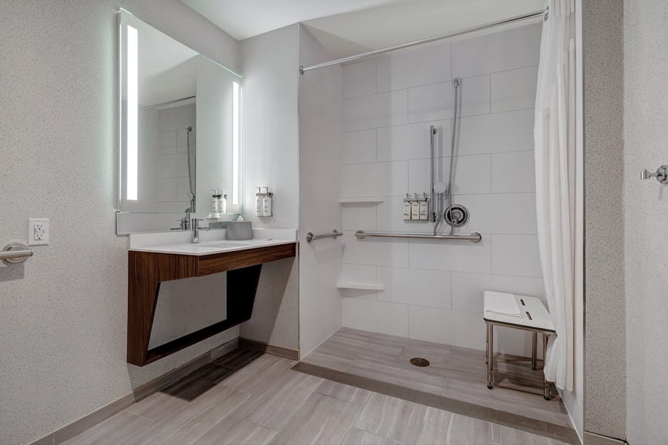 Suite, 1 King Bed, Roll-in Shower (Roll-In Shower) | Bathroom | Hair dryer, towels, soap, shampoo