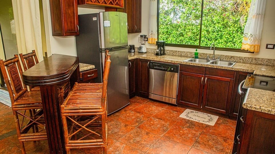 cozy kitchen features warm tones and functional design, creating a welcoming space to cook and gather