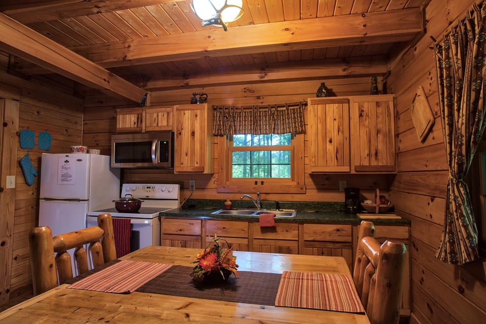 The kitchen has the essential conveniences: a stove, a toaster, a refrigerator, a coffee maker, a microwave, and cooking utensils to satisfy your culinary desires.