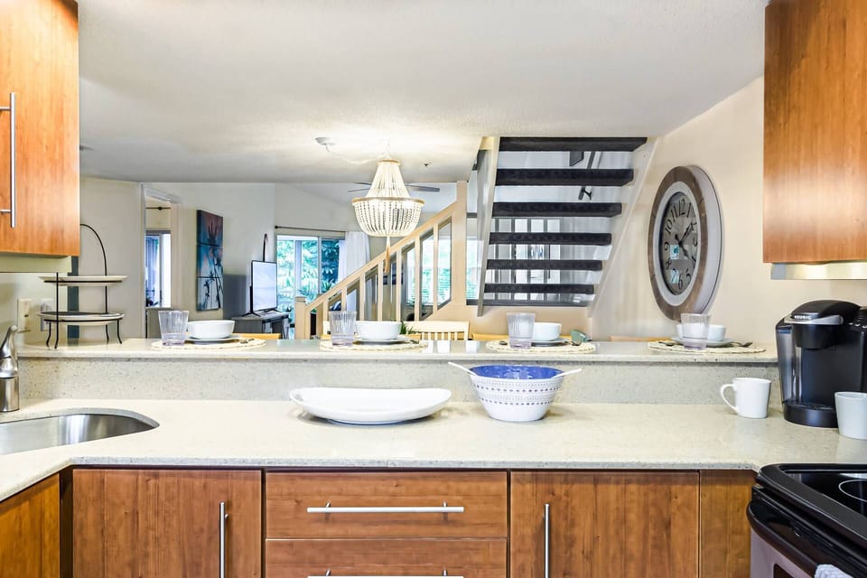 Open modern kitchen with both kitchen nook with dining for 4 and kitchen bar counter seating for 4