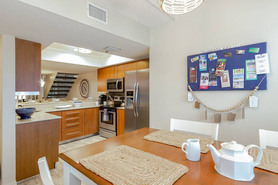 Updated modern kitchen stocked with dishes, pots & pans with bar height dining table for 4 off the kitchen.