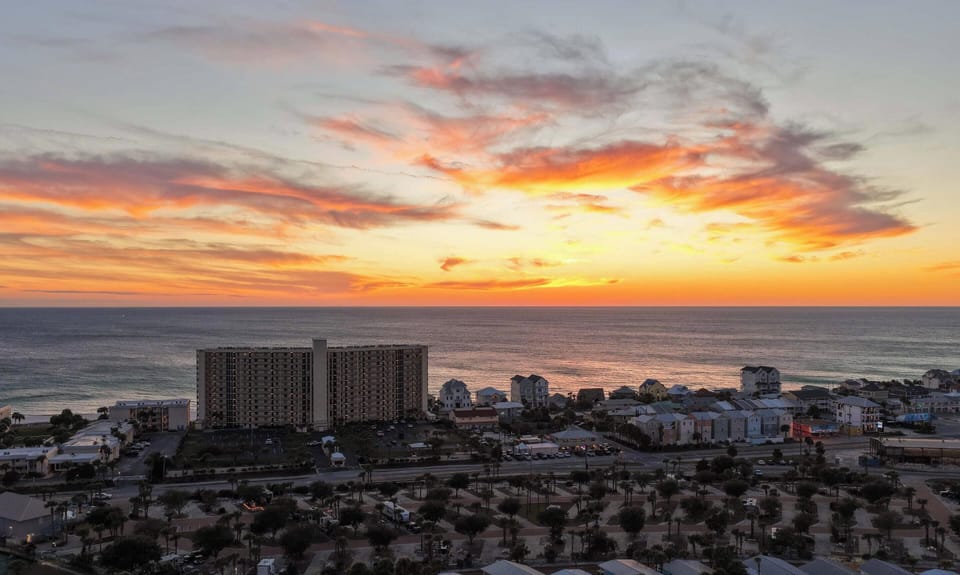 The Gulf Coast lights up in orange and pink — another perfect Panama City Beach sunset from The Commodore.