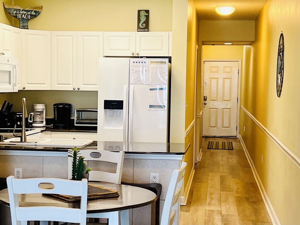Fully stocked kitchen with hallway to second two bedrooms.