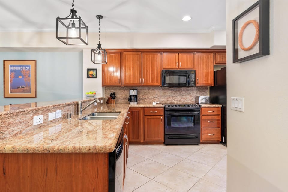 Full kitchen with breakfast bar, granite counters, and modern appliances