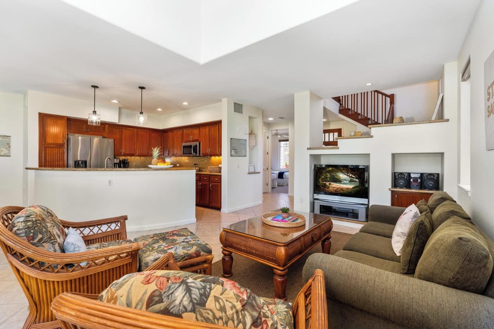 Open concept layout connects living room, dining area, and full kitchen