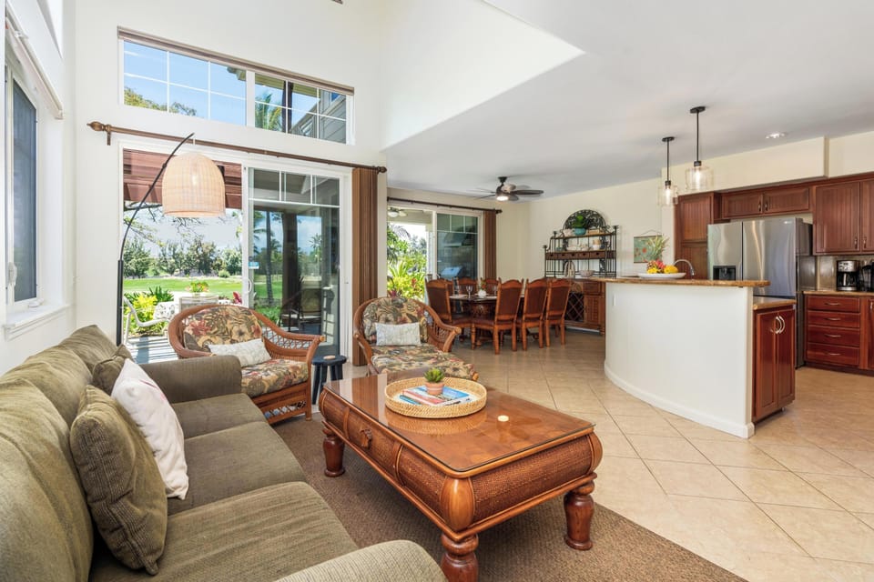 Open concept layout connects living room, dining area, and full kitchen