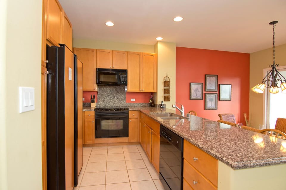 Full kitchen with granite counters and modern appliances