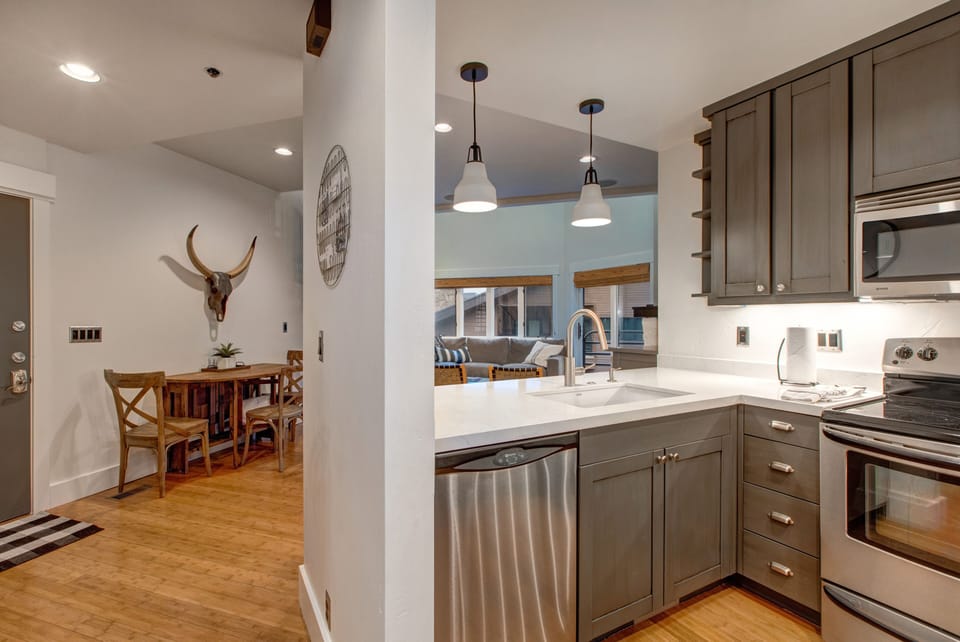 Fully Equipped Kitchen with gorgeous stone countertops, stainless steel kenmore appliances, and bar seating for four