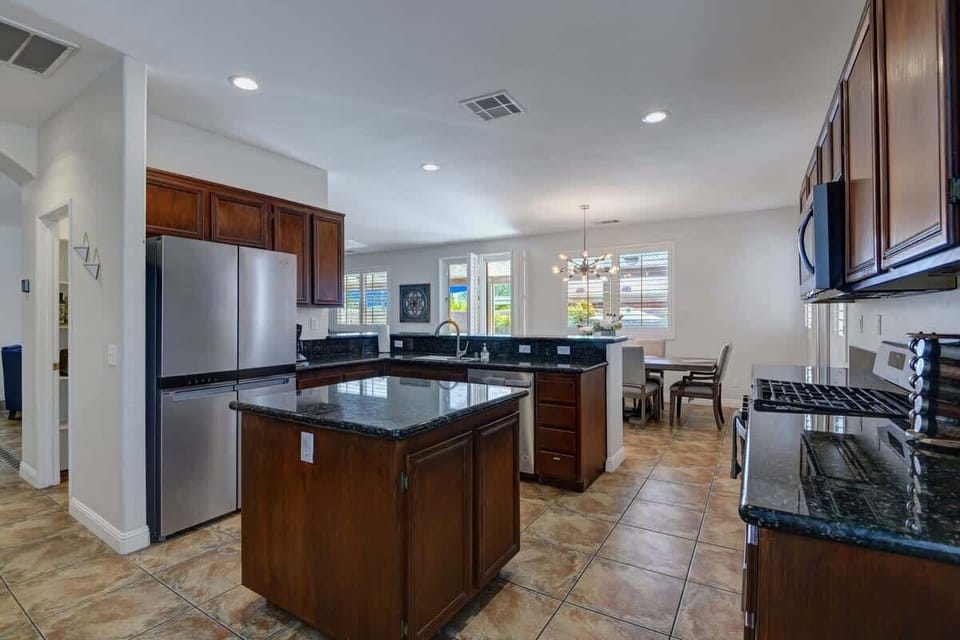 Open fully stocked kitchen with new Stainless steel appliances.