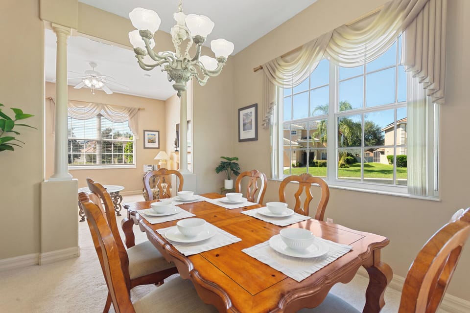 Formal dining room with chandelier at Sunset Corner Retreat by Shine Villas