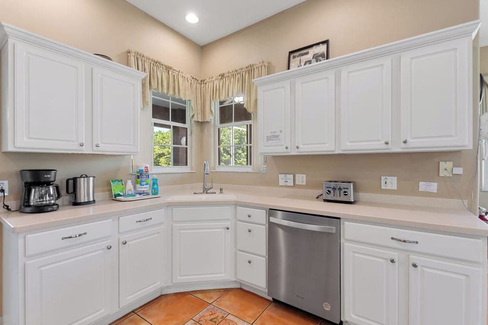Entry hallway with tile floors at Sunset Corner Retreat by Shine VillasFully equipped kitchen with stainless appliances at Sunset Corner Retreat by Shine Villas