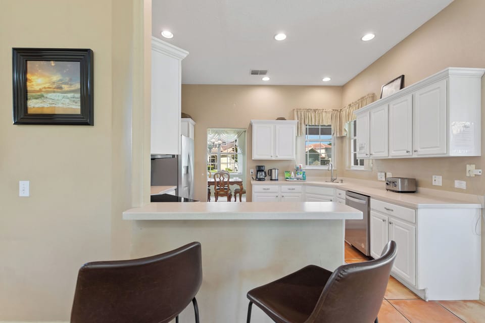 Kitchen with breakfast bar and bar stools at Sunset Corner Retreat by Shine Villas