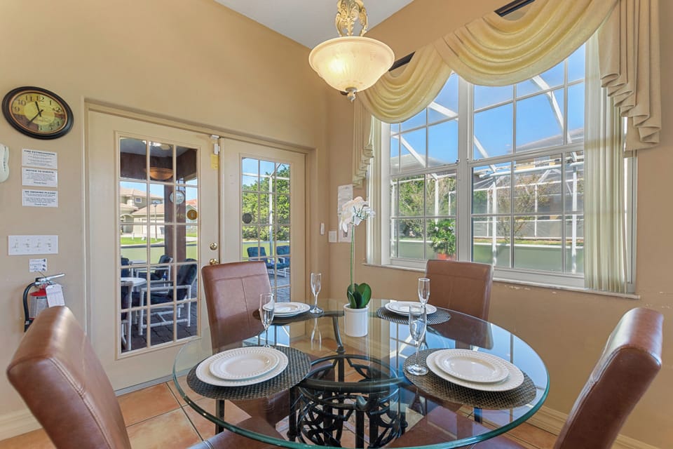Covered patio seating area with table at Sunset Corner Retreat by Shine Villas