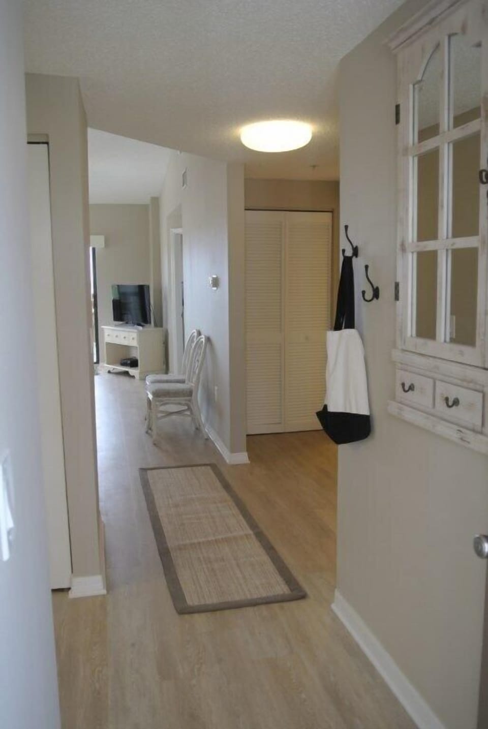 Welcoming hallway leading to a bright, inviting living area.