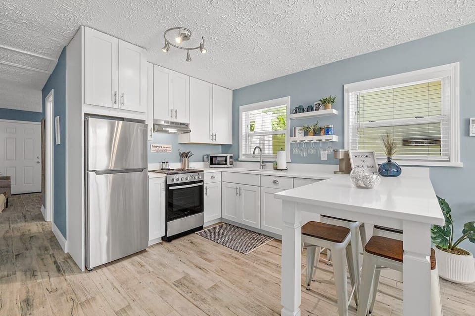 Fully stocked kitchen with island seating for 4.