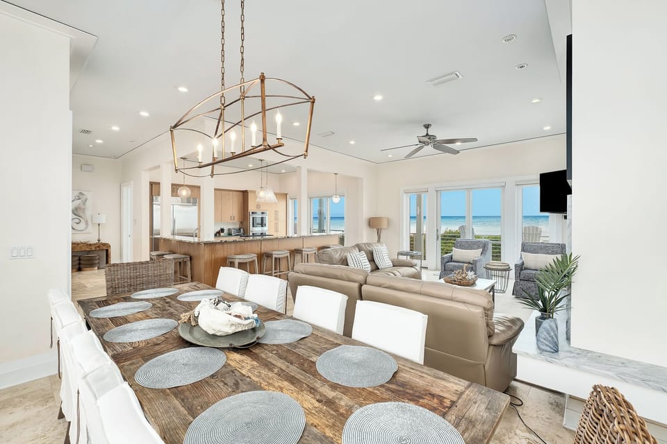 Step into your coastal haven, where airy vaulted ceilings and soft neutrals meet stunning ocean views through floor-to-ceiling windows—your perfect space for gathering, dining, and soaking in endless blue horizons.