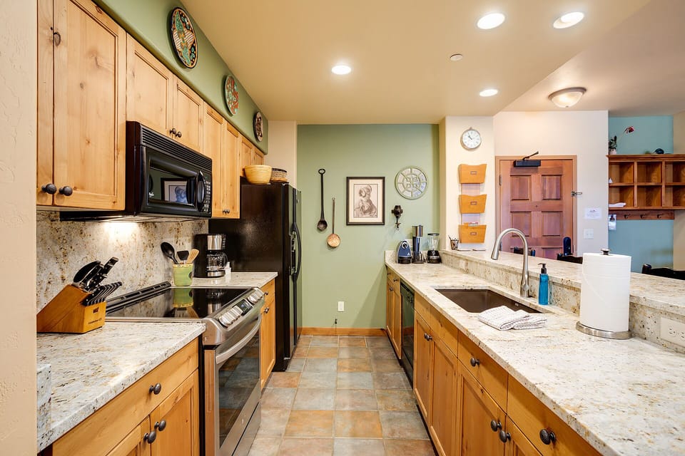 Your spacious kitchen features granite countertops, modern appliances, and ample storage for preparing memorable meals during your stay.
