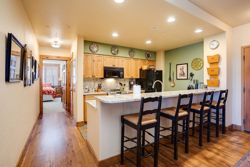 Cook together at this spacious granite breakfast bar with seating for six, fully equipped with modern appliances and charming rustic touches.