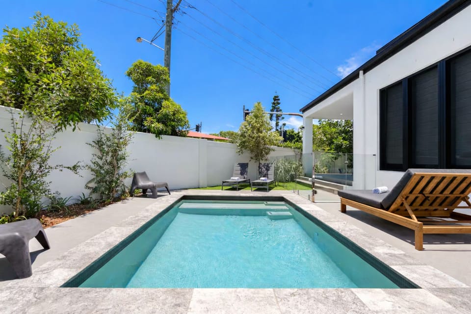 Heated private pool with seating at Luxe Capri Villa on the Gold Coast.