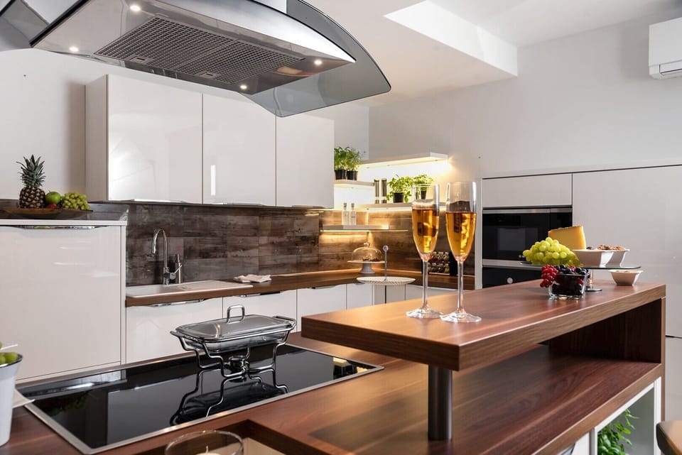 Interior of the air-conditioned modern kitchen with kitchen island on the ground floor of the modern villa with pool Happiness