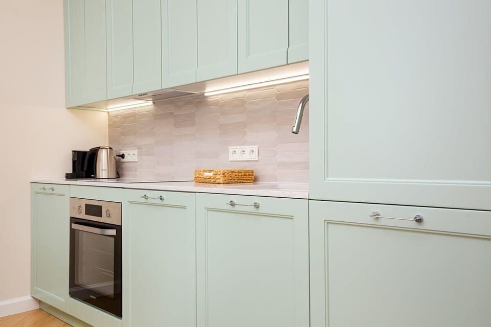Kitchenette with oven and refrigerator. 