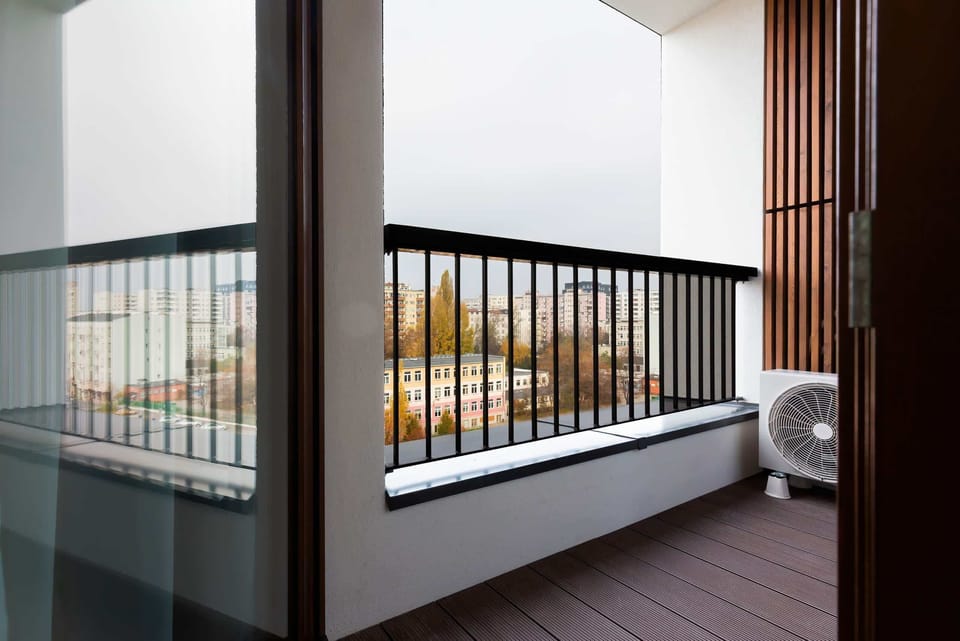 Spacious balcony with outdoor furniture. 