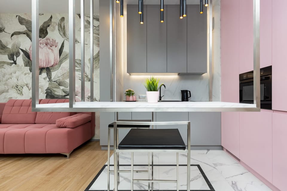  A spacious area combining a pink living room with a modern dining setup and open floor plan.