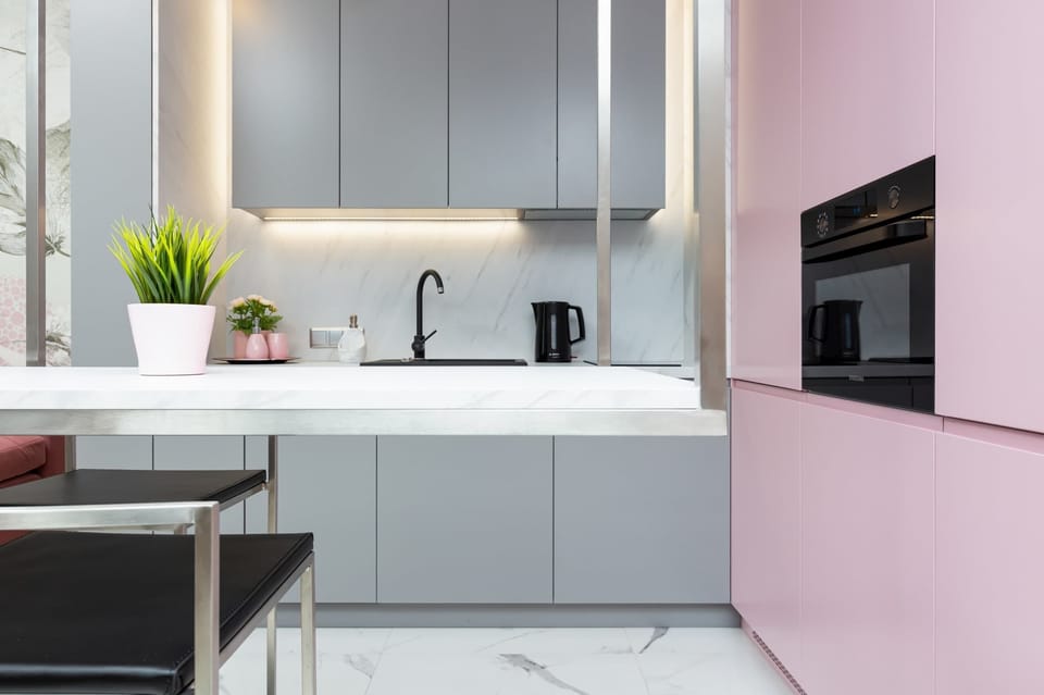 Modern kitchenette with oven and other high-quality appliances.