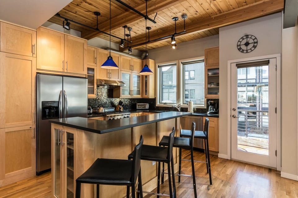The fully stocked kitchen has seating for four at the breakfast bar