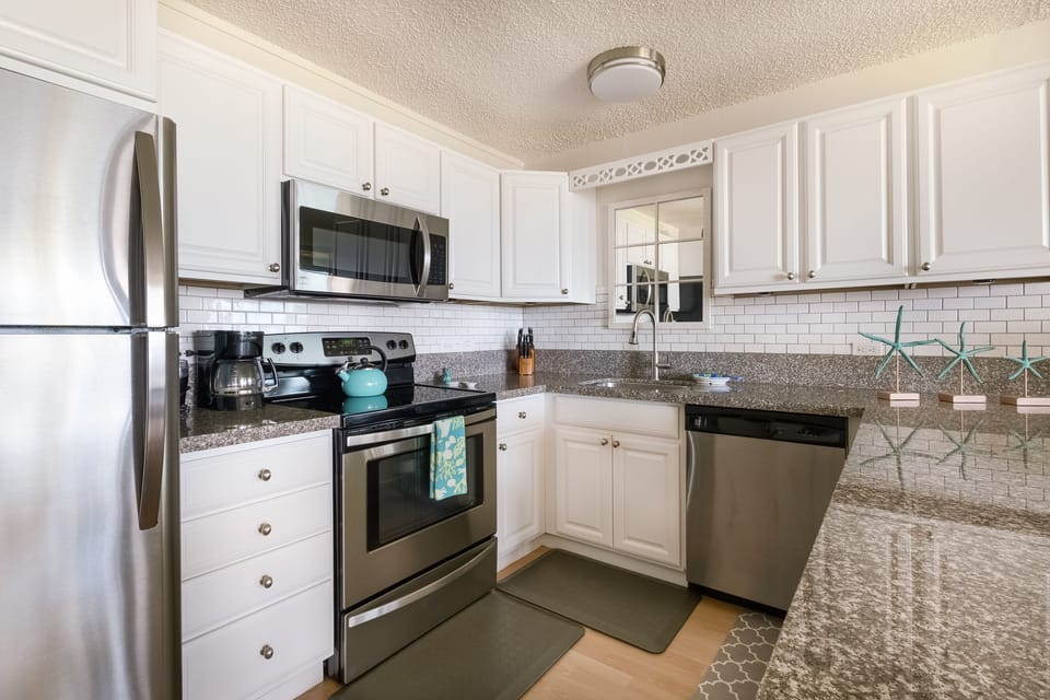 Fully appointed kitchen with chefs knife set and spice rack.