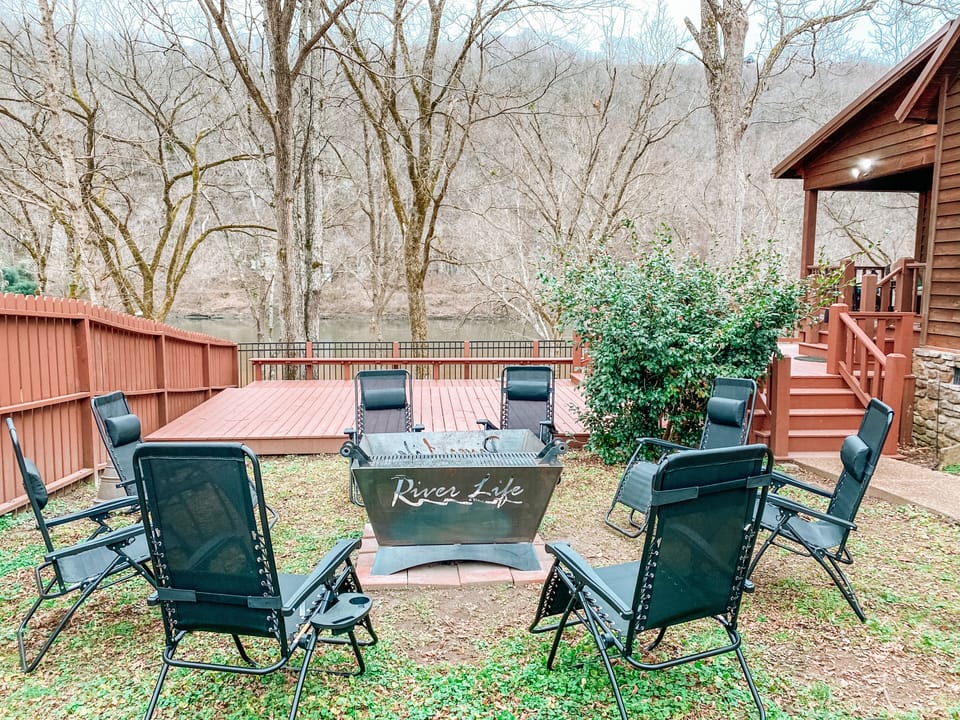 Fire pit with 8 chairs facing the beautiful white river. 