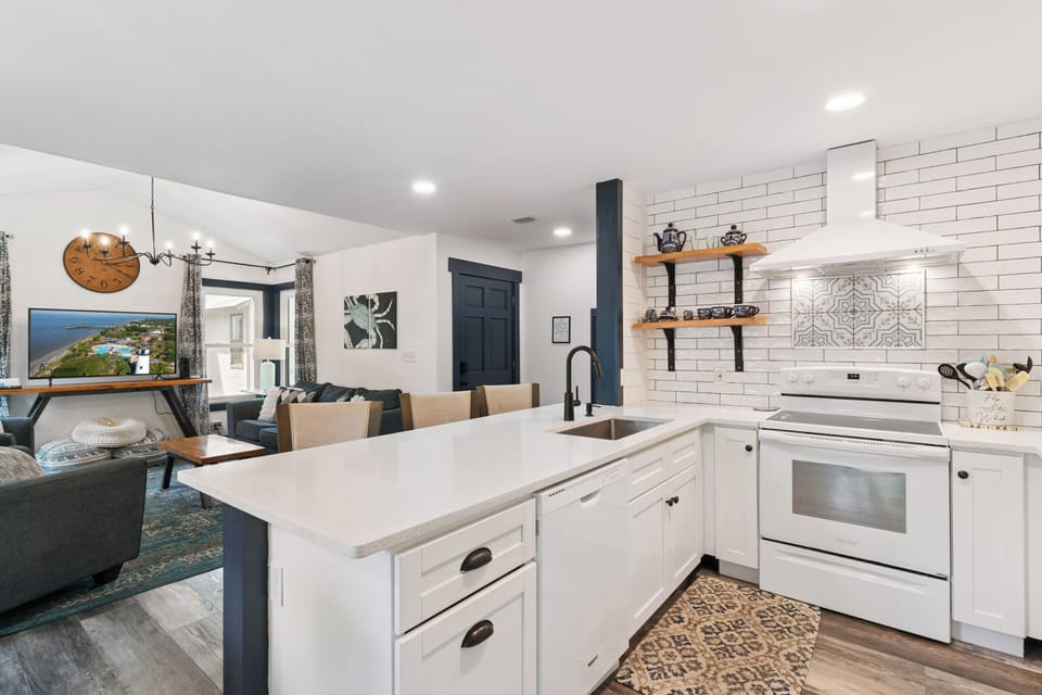 Your fully equipped kitchen awaits with modern appliances and stylish finishes, seamlessly flowing into the cozy living space where you can cook, dine, and unwind together.