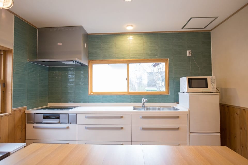 Large and comfortable system kitchen with windows and bright