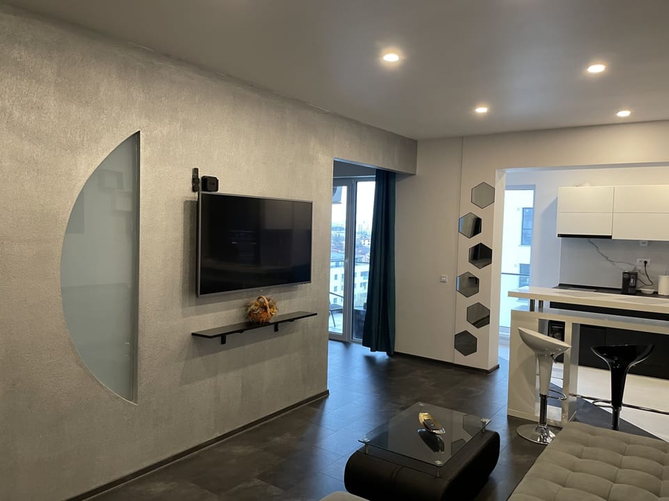 Signature Apartment | Living room | 55-inch LED TV with cable channels, TV, Netflix