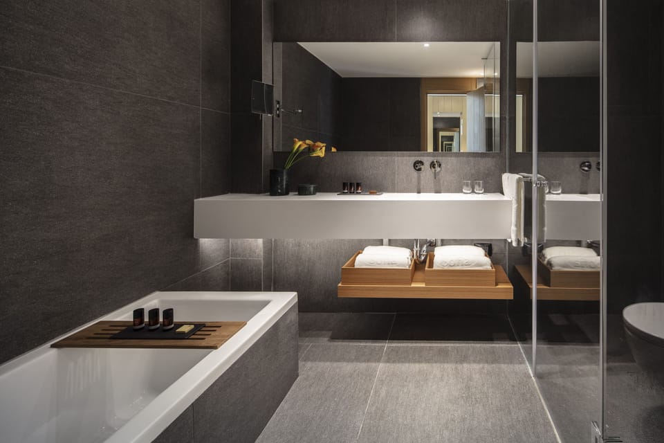 Junior Suite, Lake View | Bathroom | Shower, hair dryer, slippers, towels