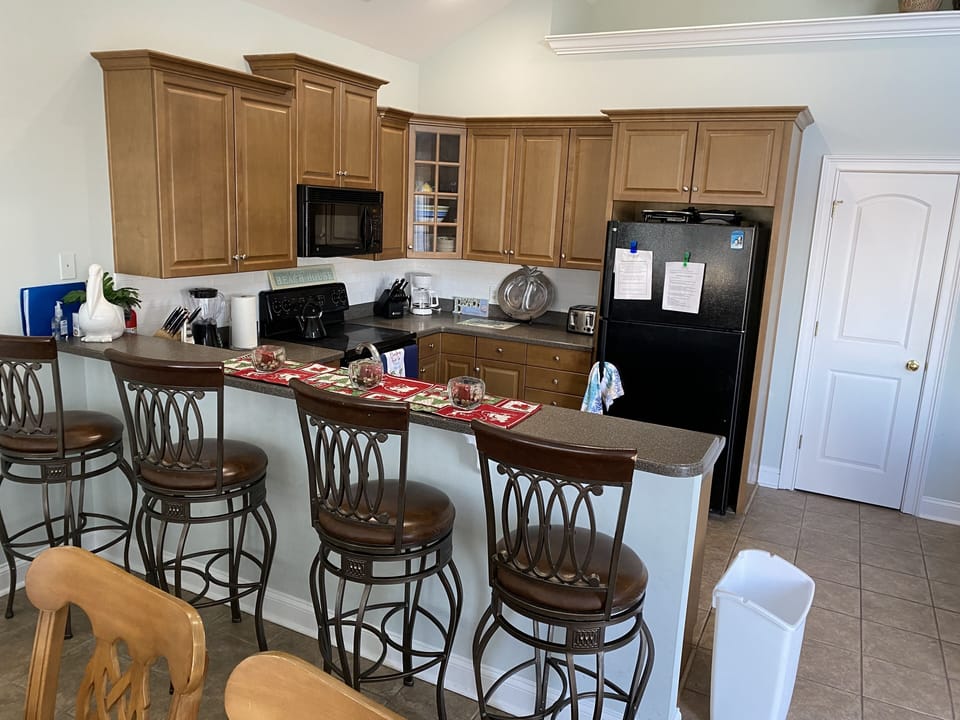 Upstairs kitchen with 4 stools at counter