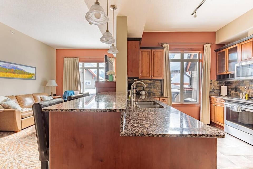 Sun-drenched kitchen contains high-end appliances, granite countertops, and all the basics you need to cook up a storm