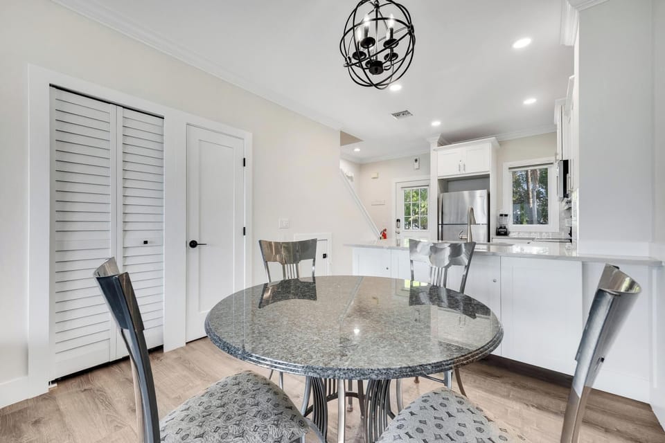 Granite table with laundry machine and half bath in the background