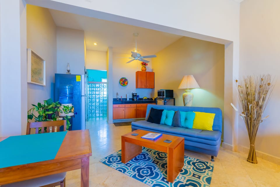 King Suite with futon, full kitchen, dining area and bathroom